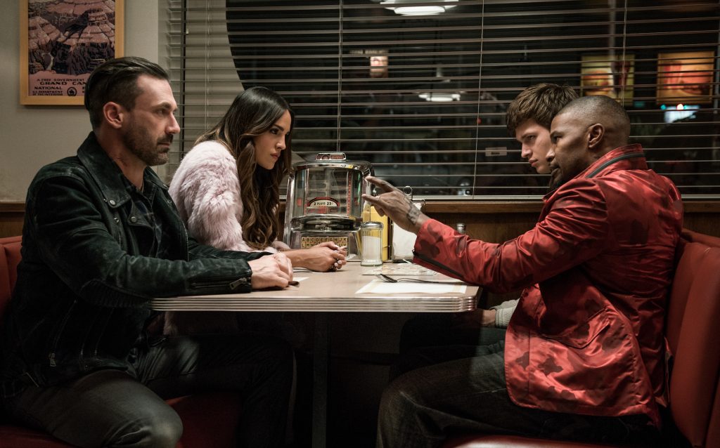 (l to r) Buddy (Jon Hamm), Darling (Eiza Gonzalez), Baby (Ansel Elgort) and Bats (JAMIE FOXX) discuss the next heist in TriStar Pictures' BABY DRIVER.